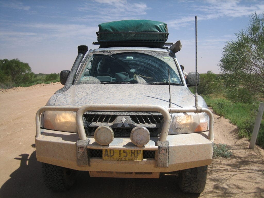 Off-Road Race Vehicle. NP Pajero covered in salty muddy water on the Oodnadatta Track