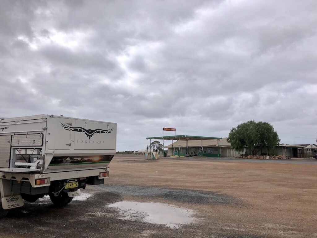 Cocklebiddy Roadhouse with large empty parking are in front of the roadhouse.