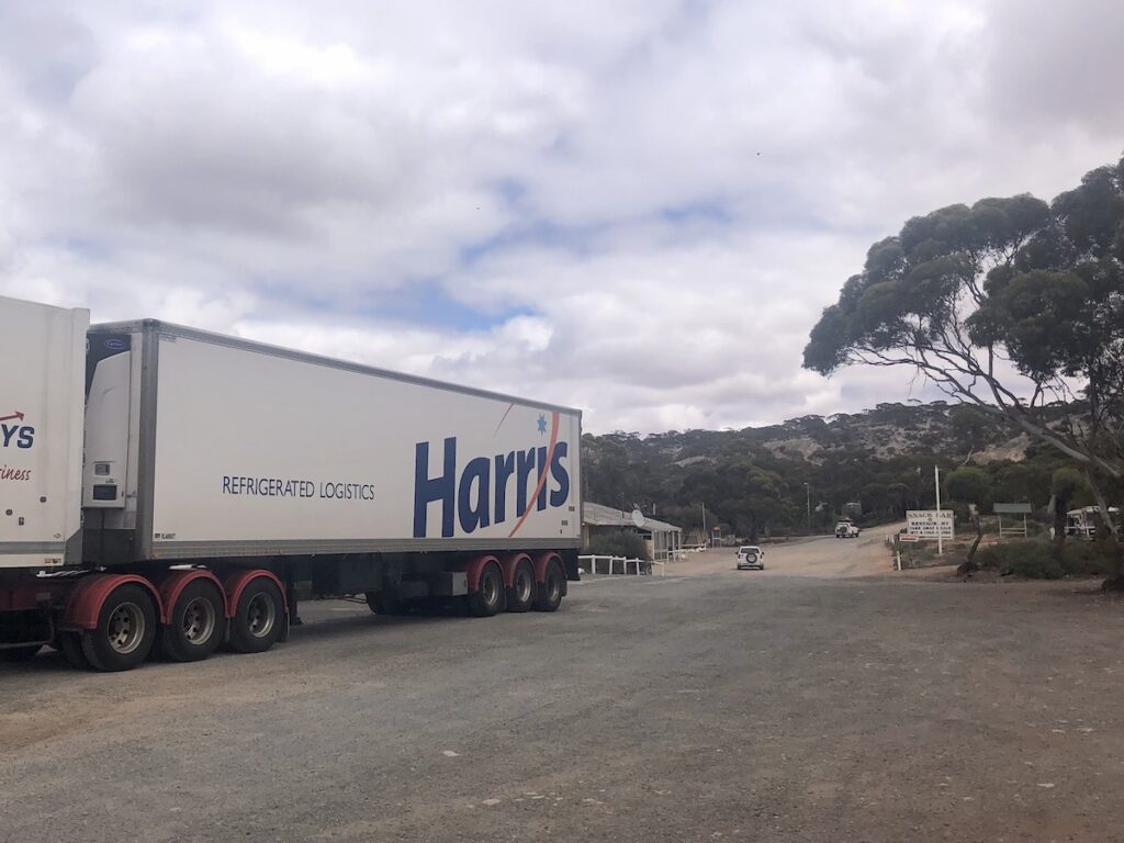 Madura Pass Roadhouse in the distance with truck in foreground.