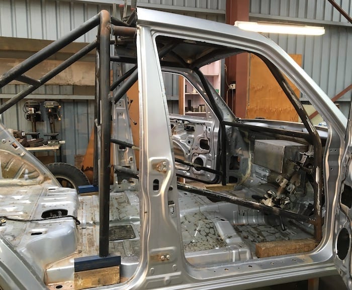 Test-fitting the roll cage in the Pajero ute