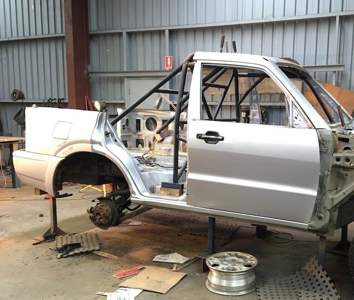 Test-fitting the roll cage in the Pajero ute