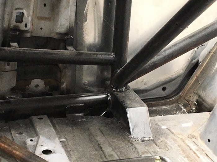 Detail of how the cage mounts to the floor behind the drivers seat