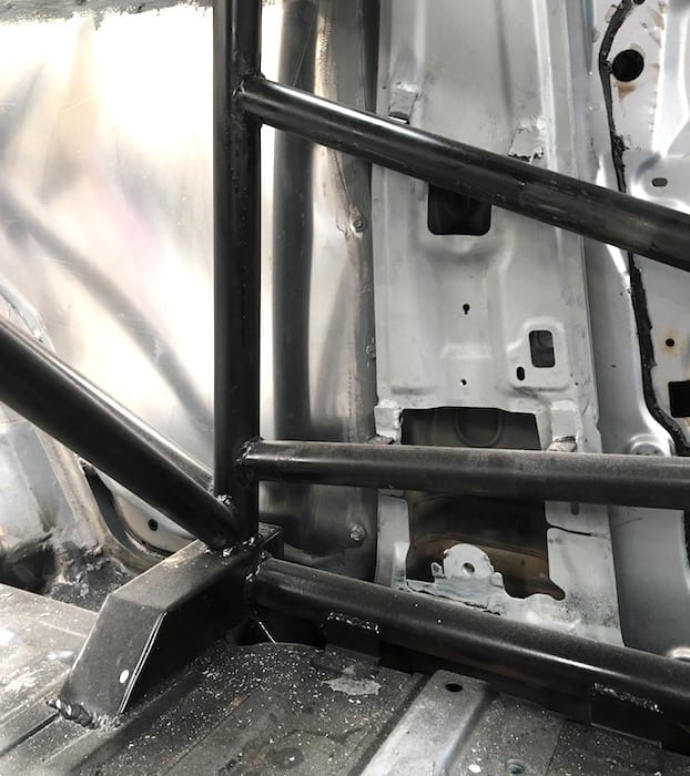 Behind the passengers seat. Details of how the roll cage attaches to the floor pan.