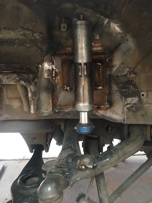 Hydraulic bump stop mounted. Bump plate also tacked onto upper control arm. Off Road Suspension.