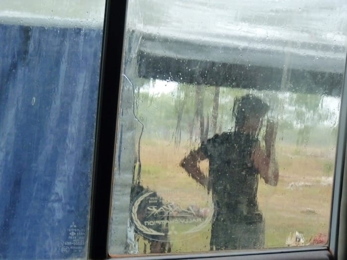 Packing down the camper trailer in pouring rain at King Edward River Campground. Kalumburu Road.