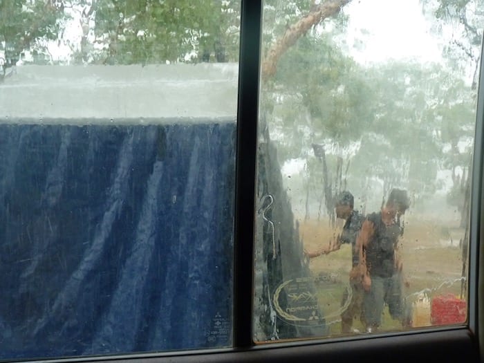 Packing down the camper trailer in pouring rain at King Edward River Campground. Kalumburu Road.