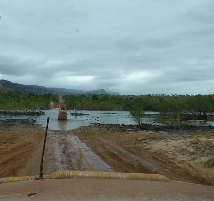 Crossing the Pentecost River. the Cockburn Range in the background is shrouded in mist. Muddy Gibb River Road.