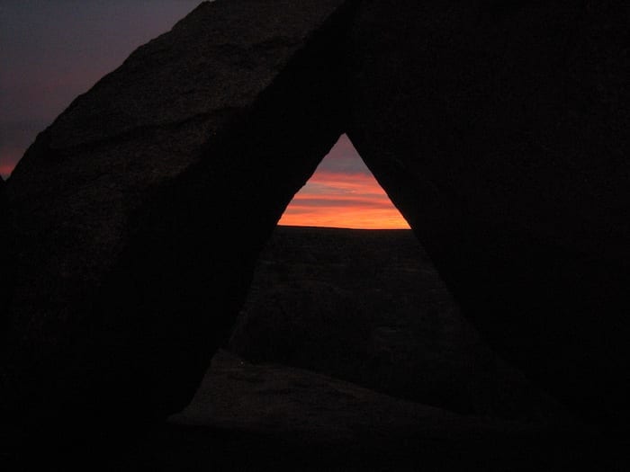 Sunrise framed by rocks. Devils Marbles.