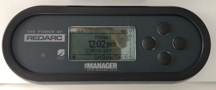 Remote monitor showing clock, REDARC Battery Management System.