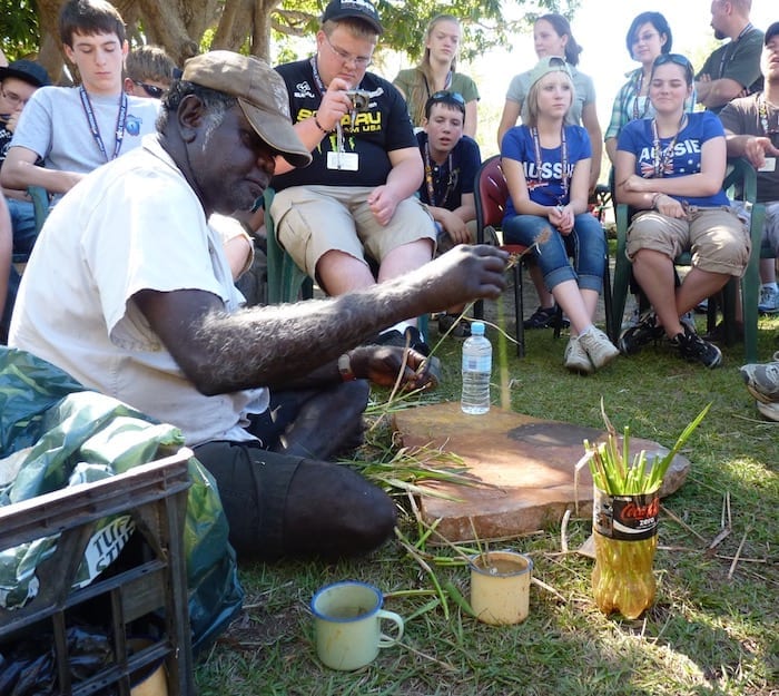 John Dewar preparing cane grass leaves to use as paintbrushes. Manyallaluk, Northern Territory.