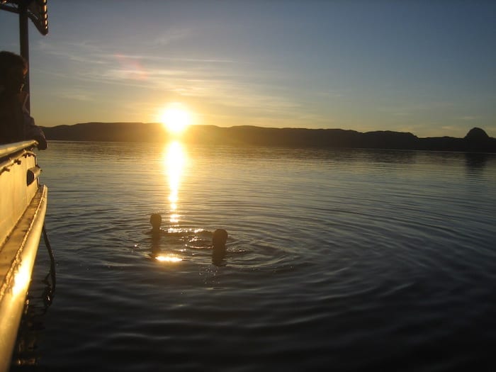 The kids swimming in the lake at sunset. Lake Argyle Cruises.