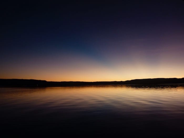 Extraordinary sunset colours reflecting off the water. Lake Argyle Cruises.