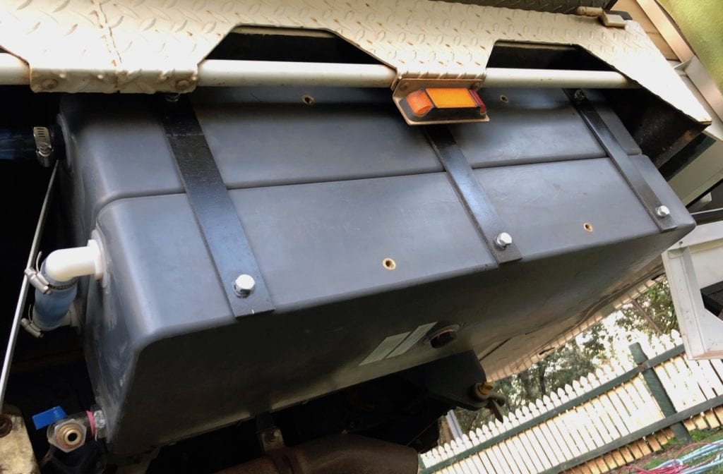 The poly water tanks tuck up under the tray.