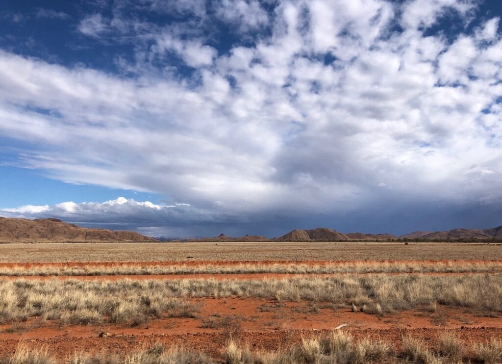 Rain clouds to the south-east of Tanami Road, over the MacDonnell Ranges.