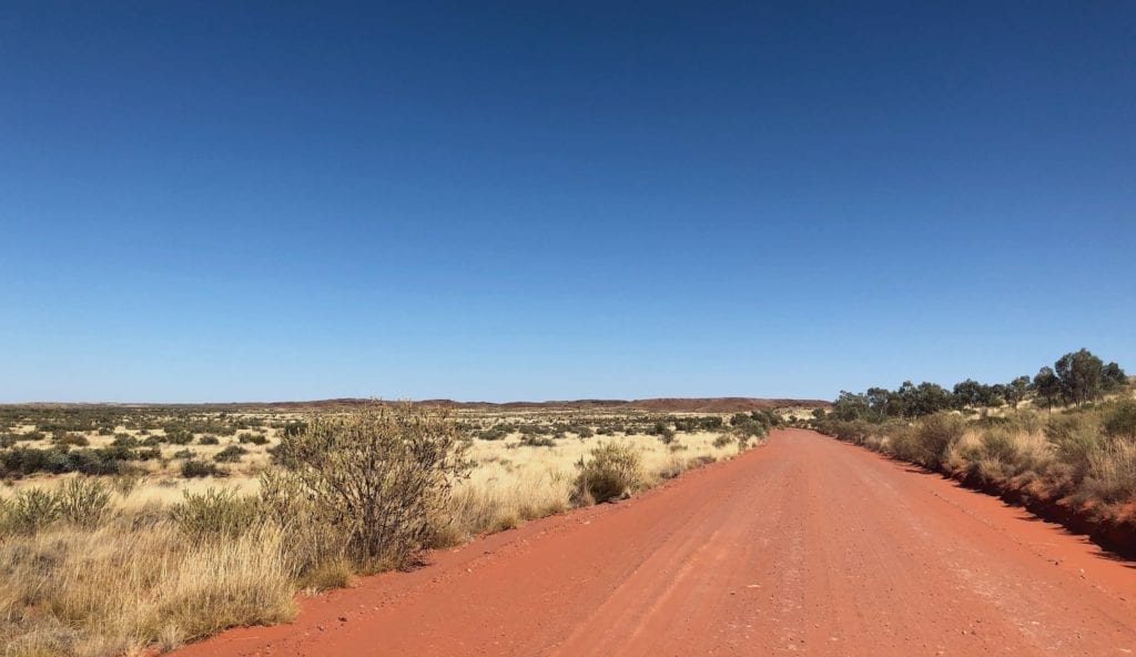 Sand dunes, spinifex and ancient mountains along Gary Junction Road.