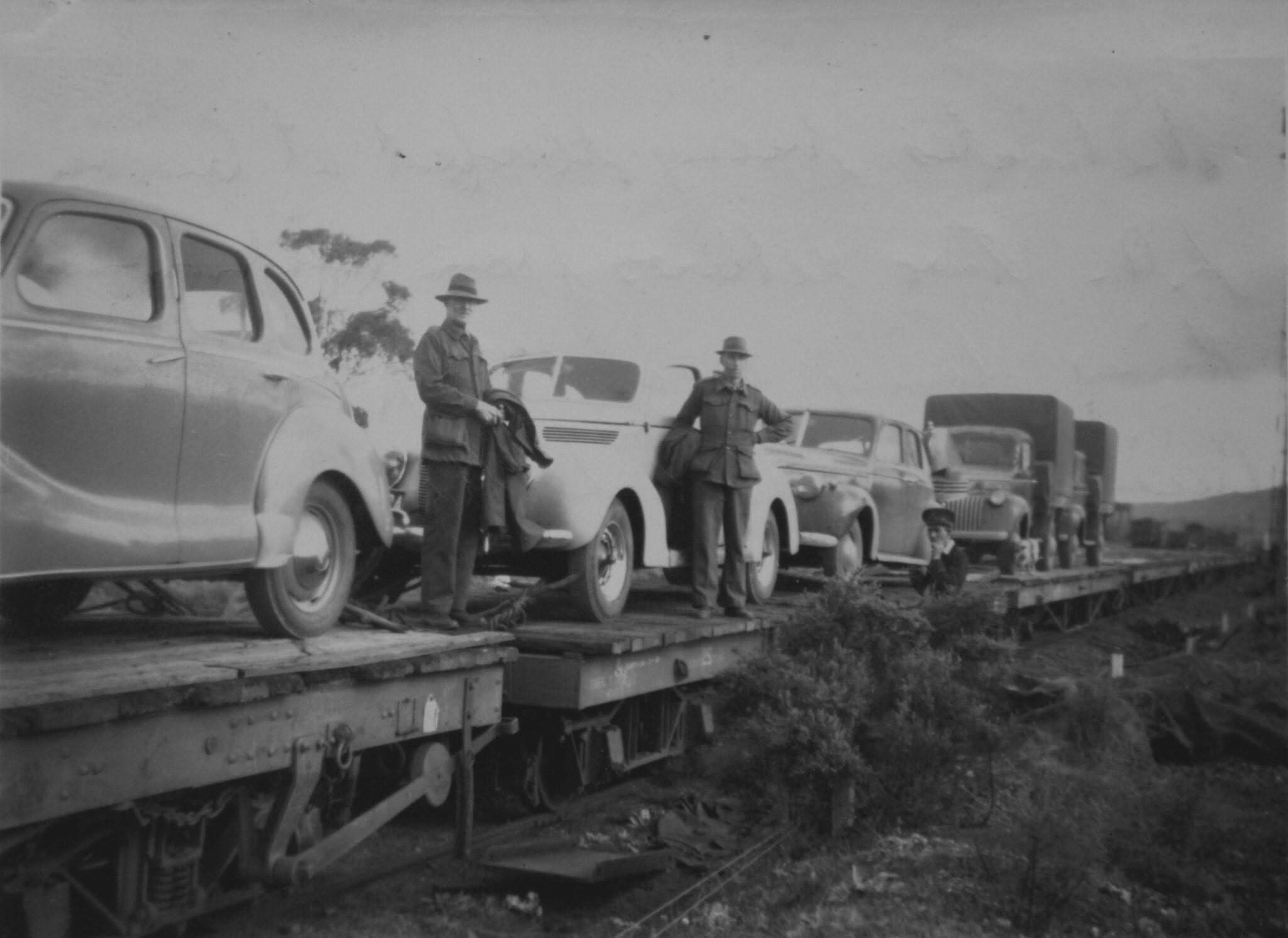 Vehicles being loaded at Quorn S.A. Two fellows from Richmond River doing round trip via Darwin, Cairns etc also "Sally". Old Ghan.