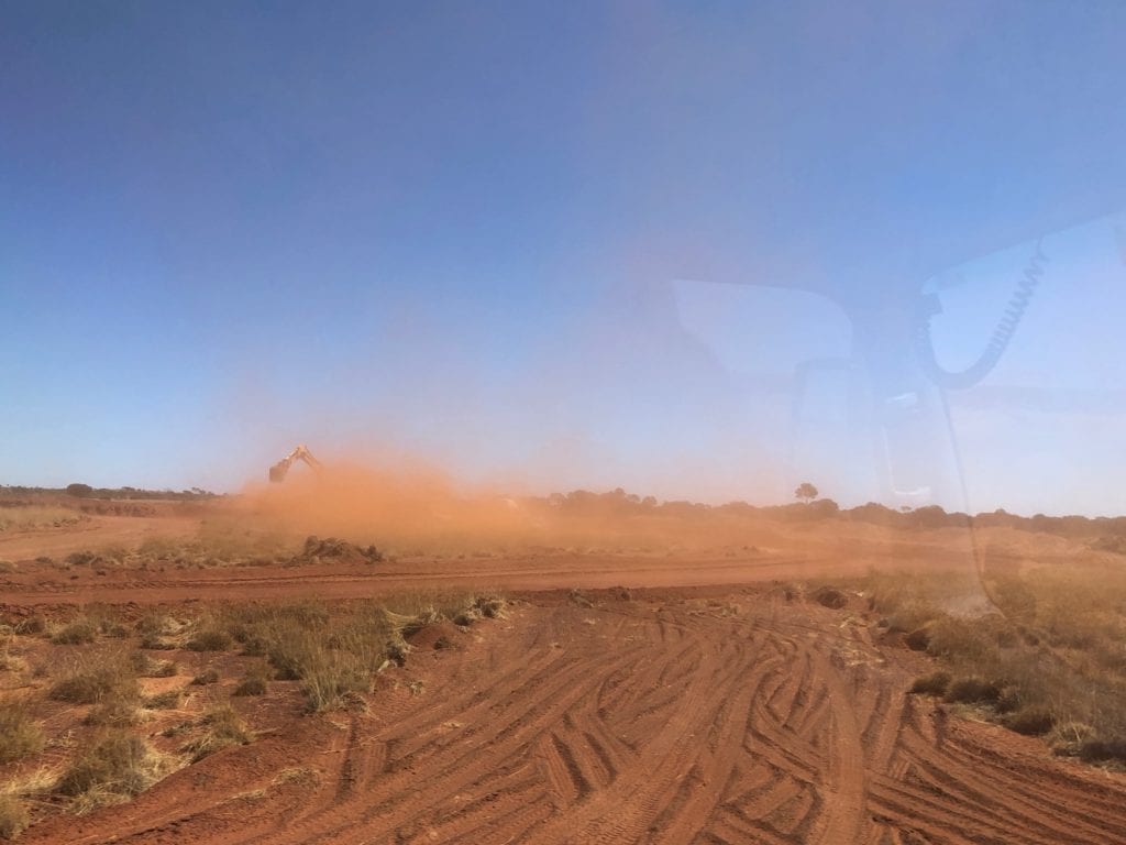 Somewhere in this dust cloud is an excavator and triple road train. Great Central Road Condition.