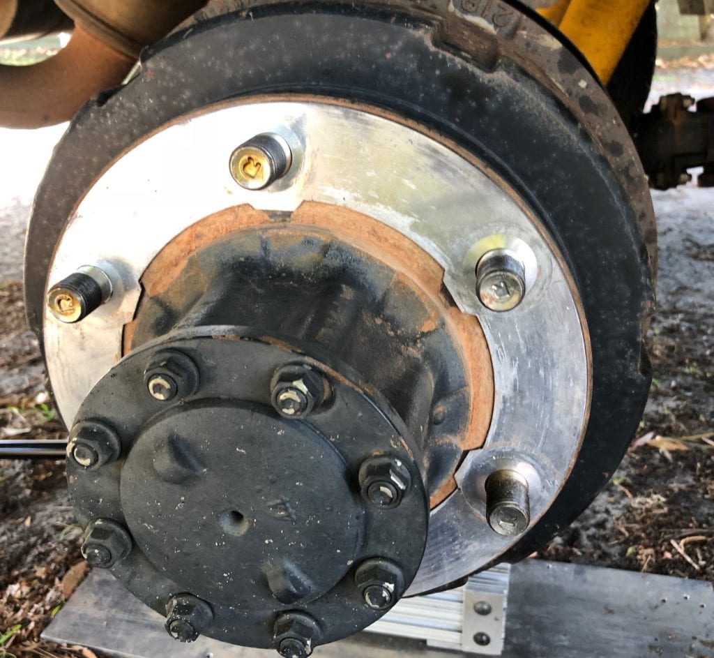 The aluminium shim after the tabs were cut off. Is now used to prevent rust stains on the alloy rims.