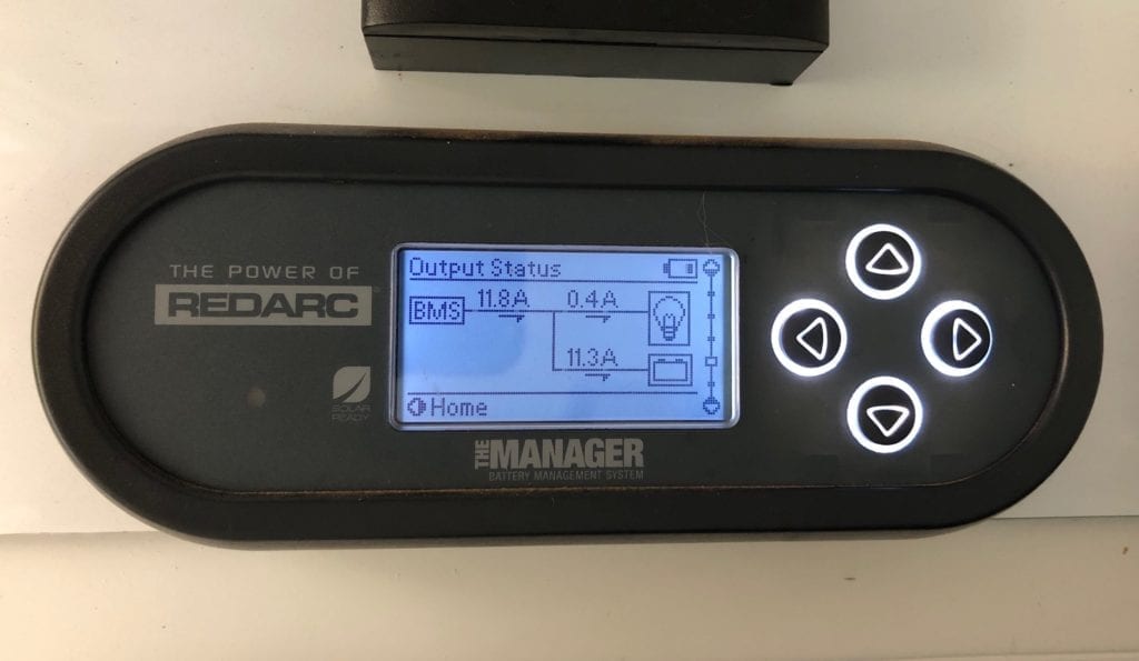 The REDARC battery monitor showing current output to battery with 2 solar panels connected.