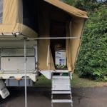 Wedgetail Camper brace pole runs horizontally above the steps. We added this to support the awning over the stairs. It was bending in during strong winds.