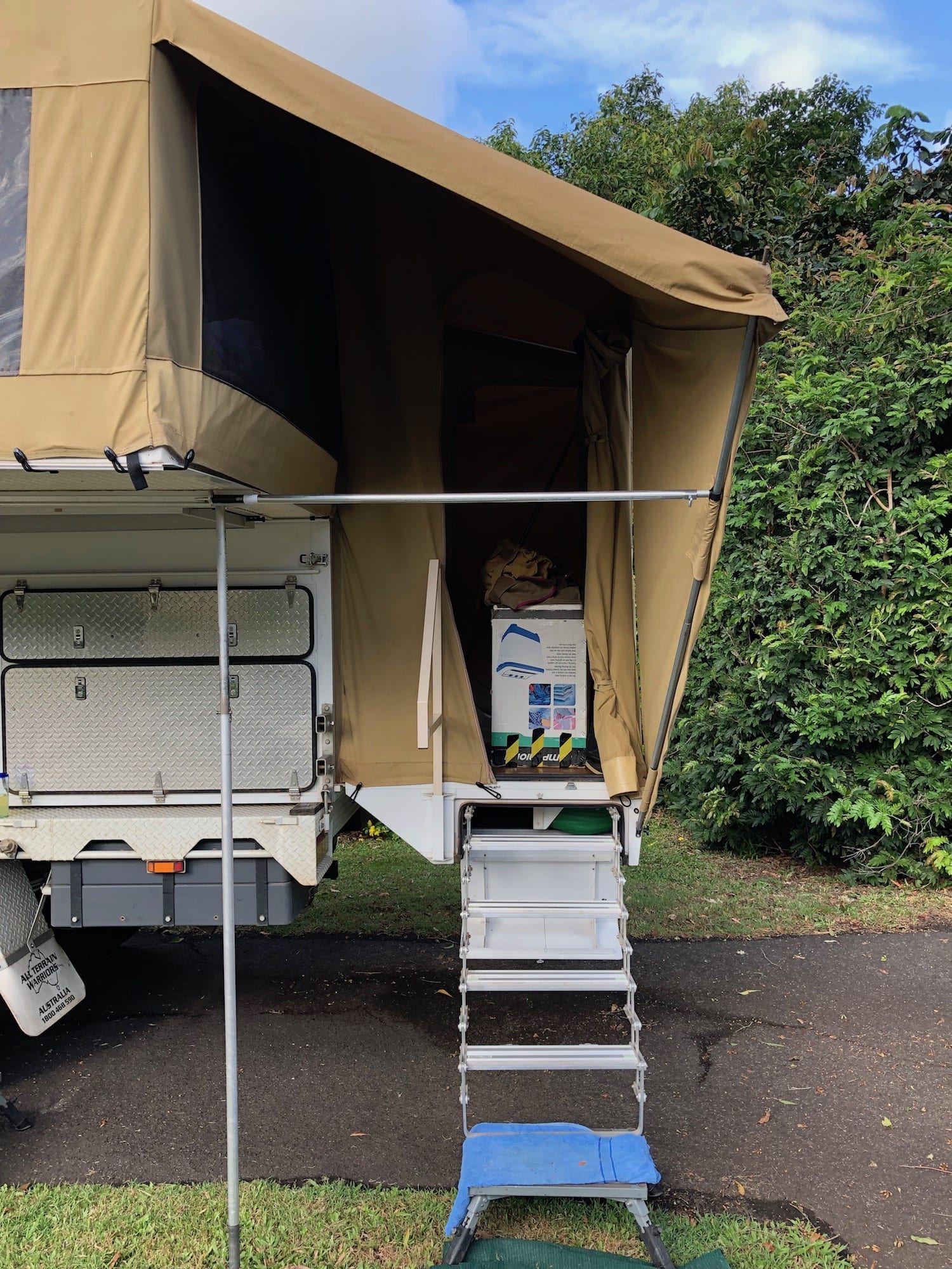 Wedgetail Camper brace pole runs horizontally above the steps. We added this to support the awning over the stairs. It was bending in during strong winds.