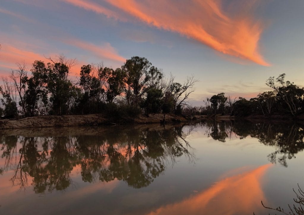 Camping On The Murray River. Bright orange clouds reflecting off the river.