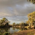 Camping On The Murray River, early morning light with dark clouds approaching.