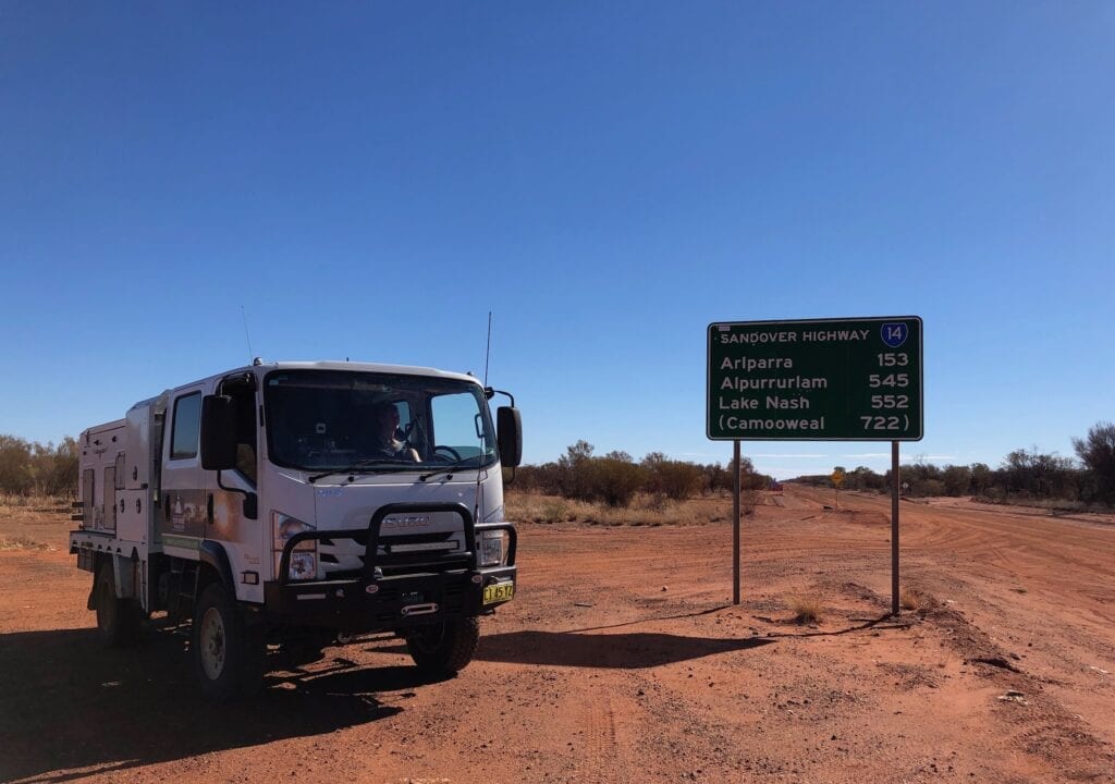 Parked in front of the "Sandover Highway" sign at the eastern end.