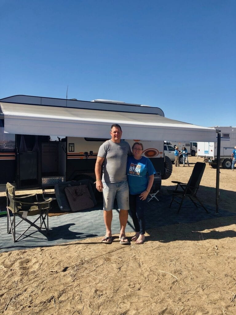 Volunteers Brett and Kelly from Central Coast NSW, outside their van at the Big Red Bash.