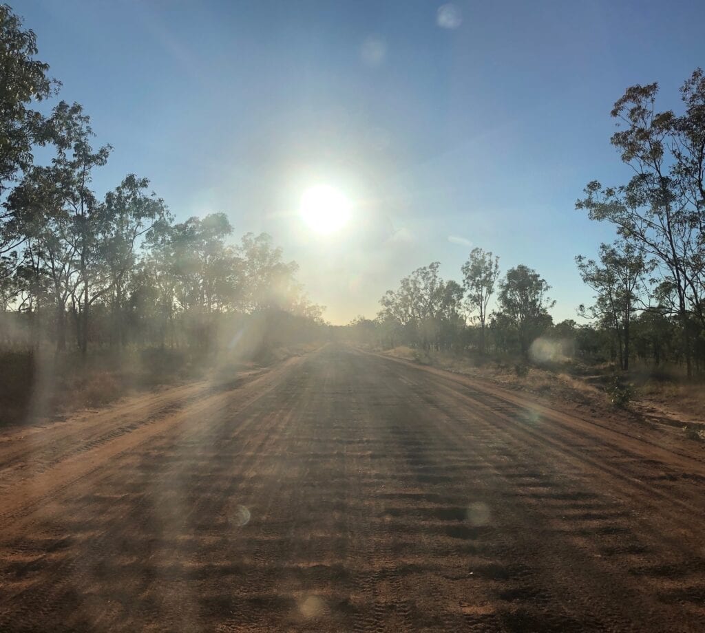 Driving east into the blinding sun, east of Borroloola NT.