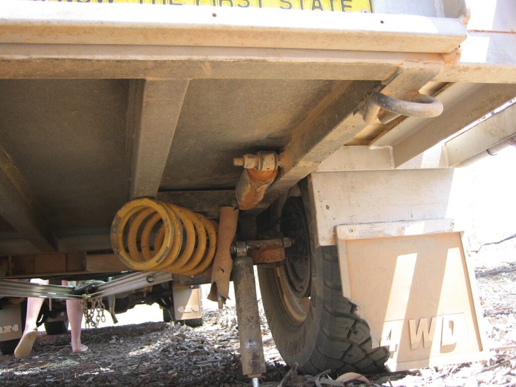 Preparing for the worst. After this suspension failure on a mate's camper trailer, we managed to get it over 200km on rough corrugated roads. We held it all together with ratchet straps.