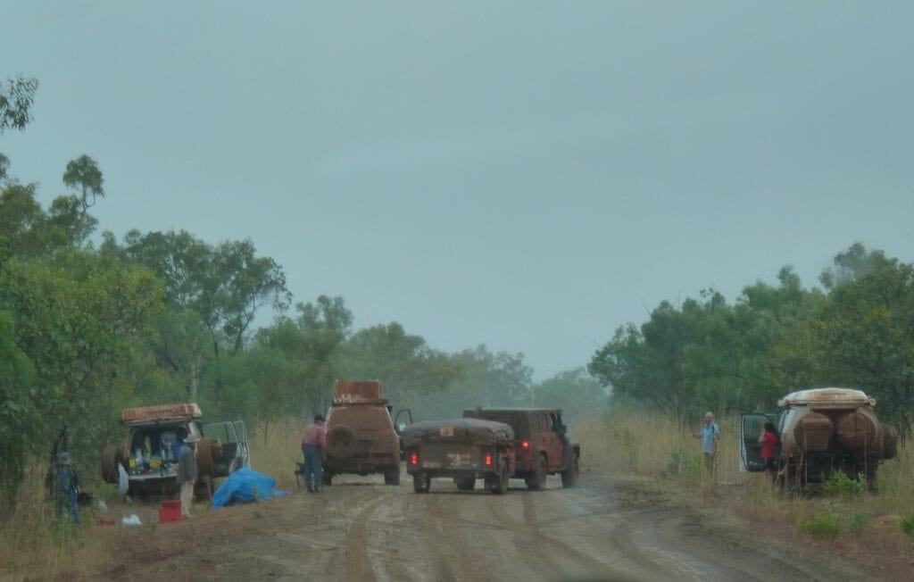 Preparing for the worst. The vehicle on the left had a broken axle and they were stranded in pouring rain overnight. It's times like this when you need a waterproof tarp to lie on.