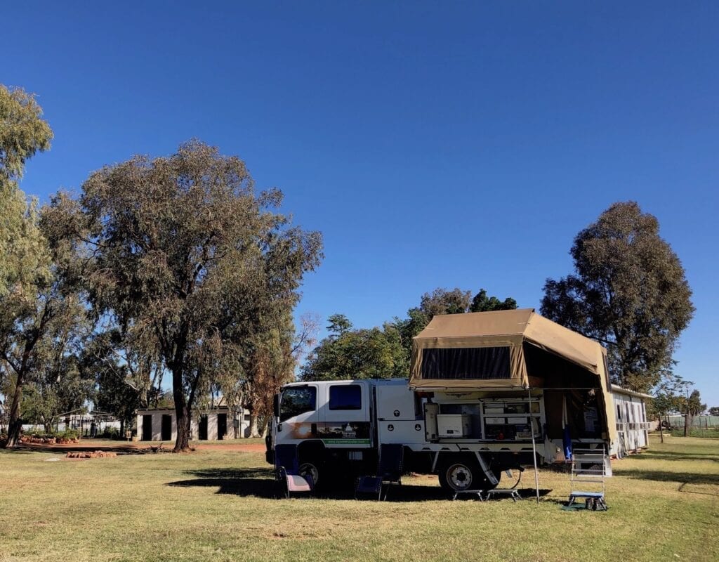 Camped on the inviting green grass at Wanaaring Store and Caravan Park NSW.