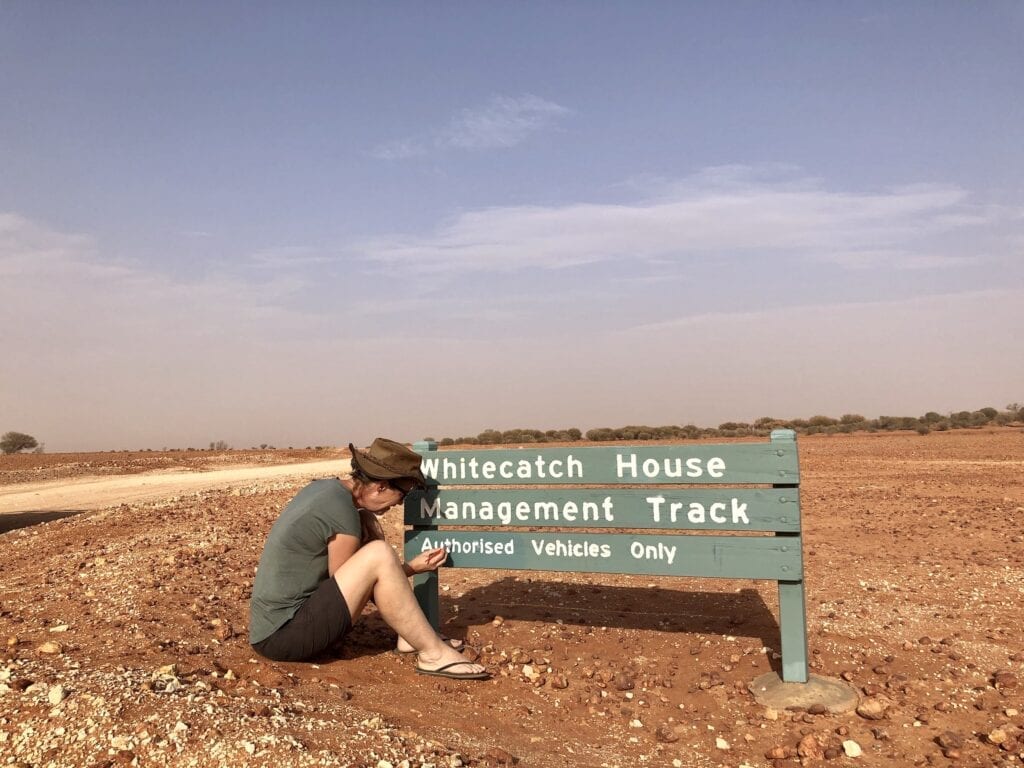 Touching up the paintwork on a vandalised sign in Sturt National Park. One of the jobs we did during our caretaker role at Fort Grey.