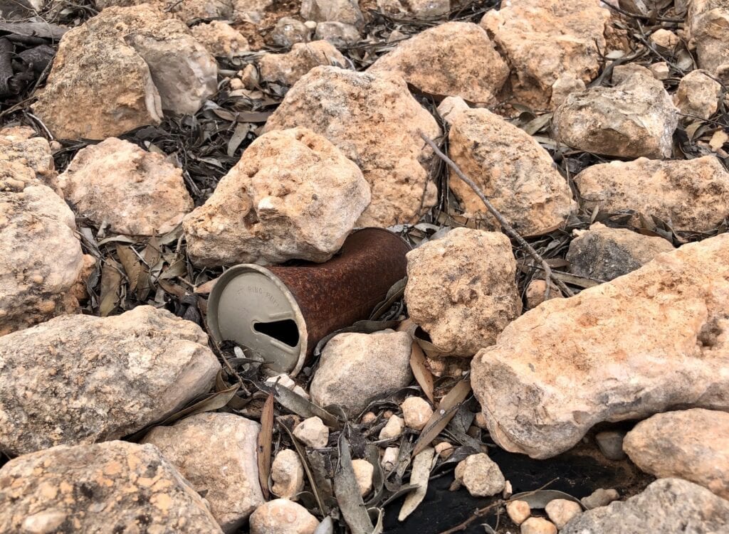 Lots of old tin beer cans are lying along the edge of the Old Eyre Highway. Nullarbor Plain, SA.