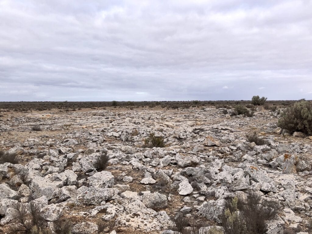 The surface of Koomooloobooka Cave looks like a jumble of limestone rocks. However, there is a cave system under the surface. Old Eyre Highway, Nullarbor Plain SA.