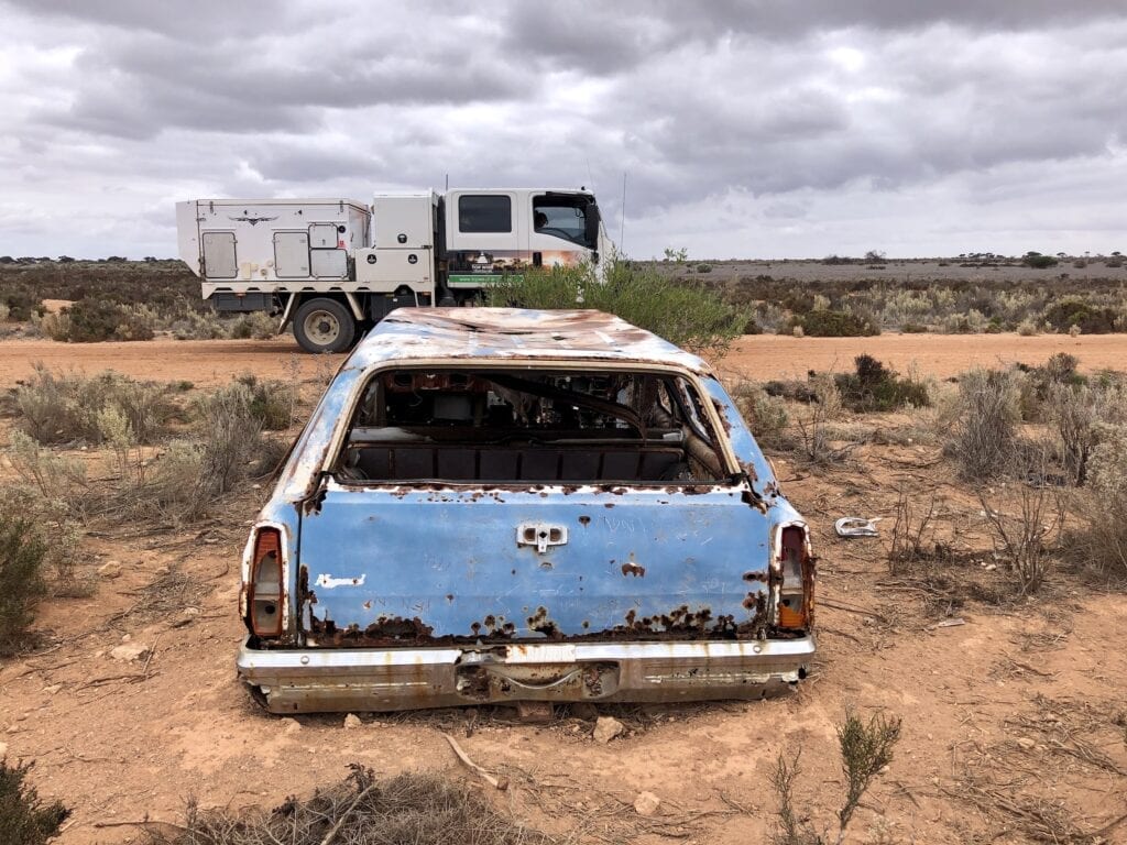 Wreck of a HQ Holden beside the Old Eyre Highway. Nullarbor Plain, SA.