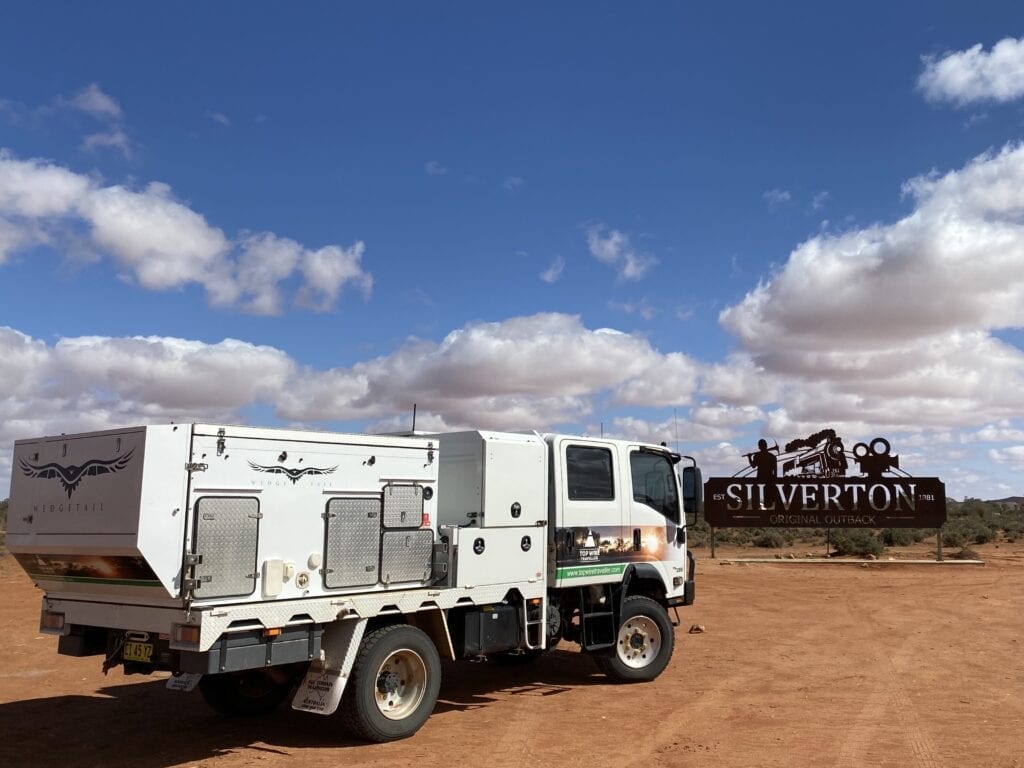 Our Isuzu truck camper in front of the Silverton, NSW welcome sign.