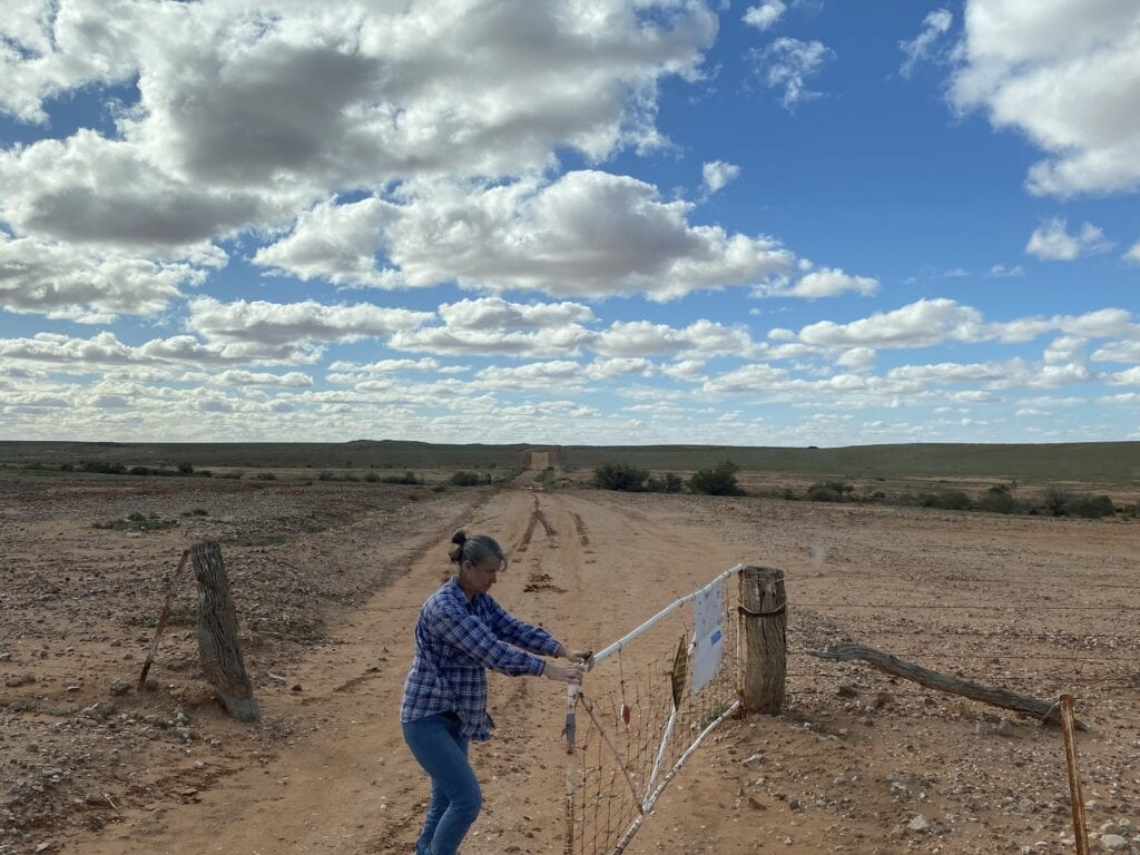 Opening one of dozens of gates on the back road from Silverton to Milparinka. Corner Country NSW.