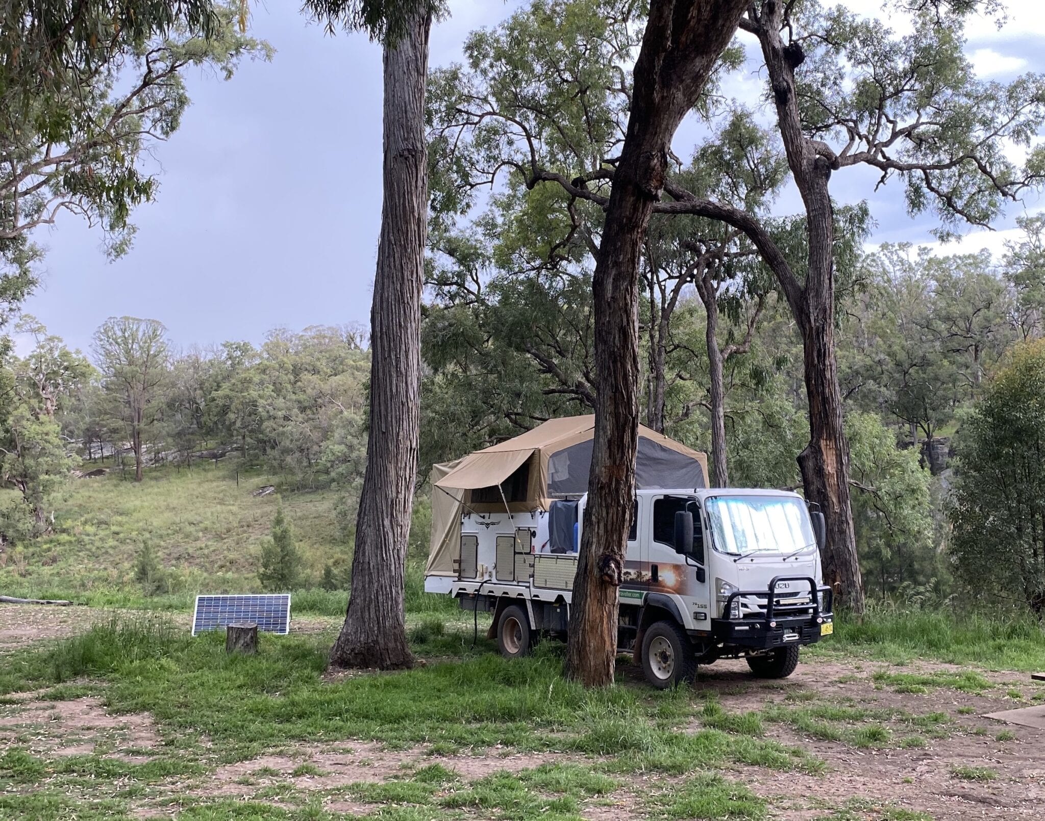 Wedgetail slide on camper and Isuzu 4WD truck camped at Goulburn River National Park.