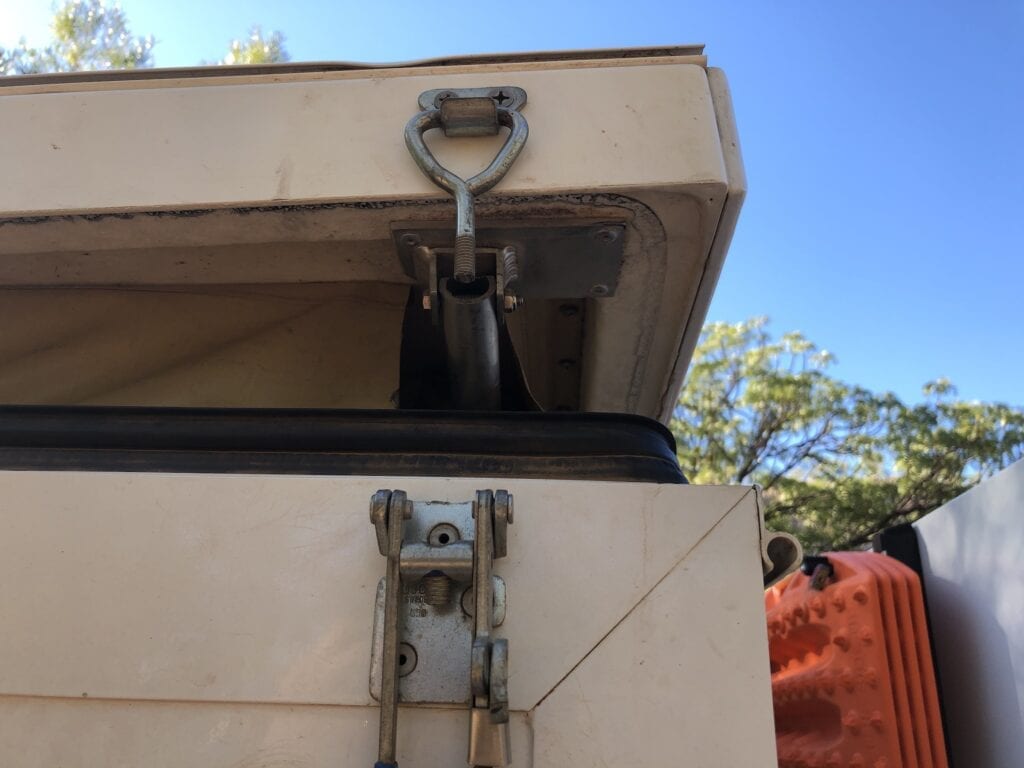 The camper lid latch sheared off due to extreme corrugations.