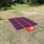 REDARC 112W amorphous solar blanket opened out, flat on the ground.