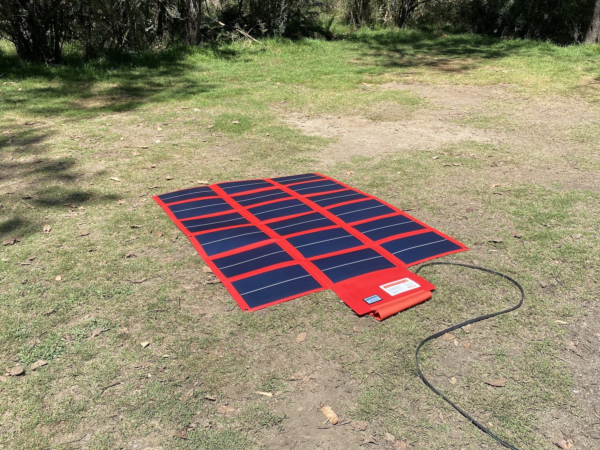 REDARC 112W amorphous solar blanket opened out, flat on the ground.