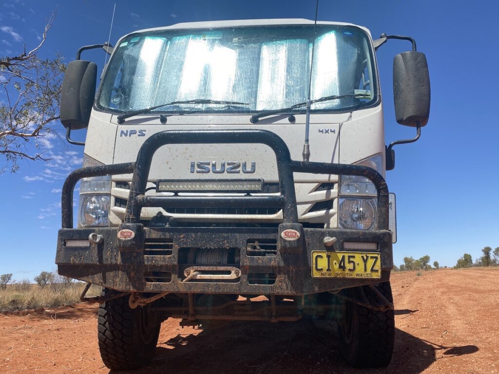 Muddy Isuzu NPS 4WD truck at the Dig Tree in south-western Queensland.