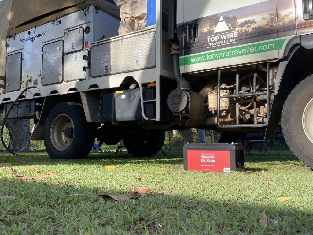 REDARC 200Ah lithium battery in front of an Isuzu NPS with a Wedgetail Camper.