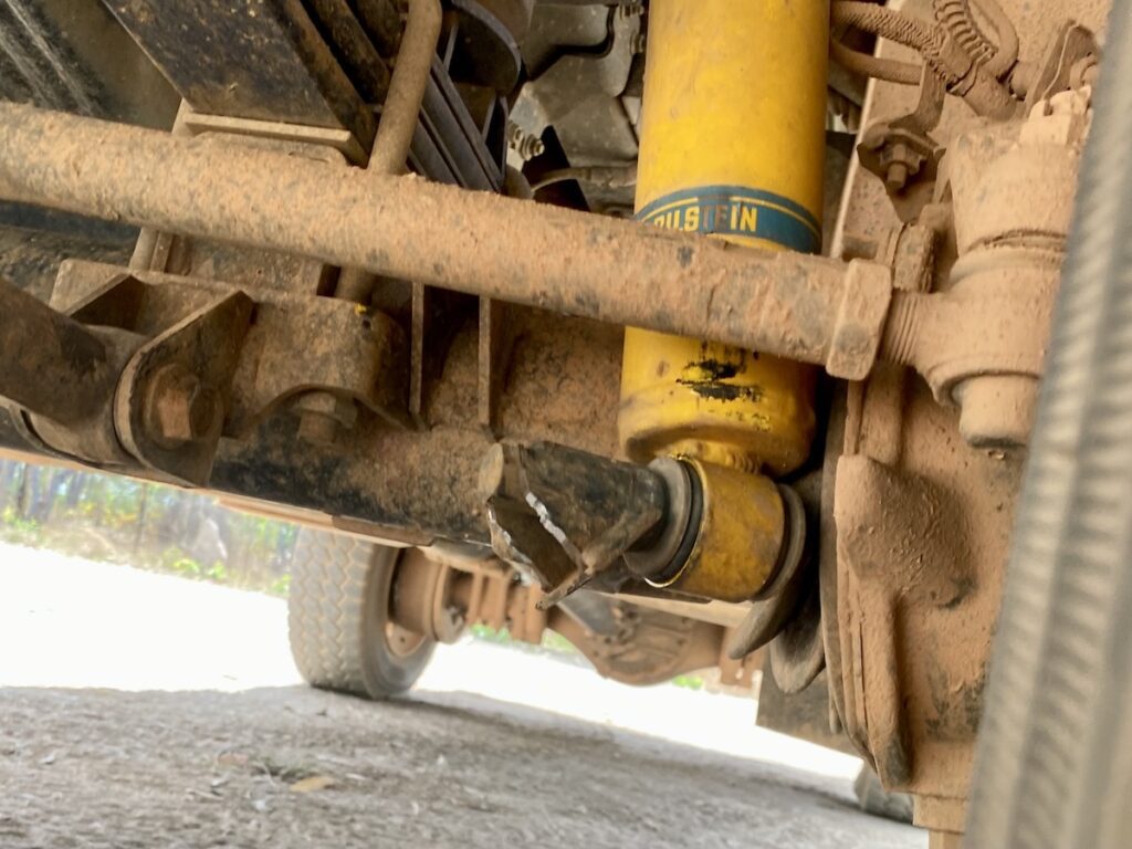 Bottom front left shock mount broken on an Isuzu 4WD truck. At Rinyirru (Lakefield) National Park, QLD.