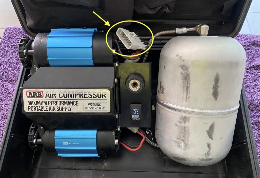 Portable ARB air compressor showing under-sized cable connector plug.