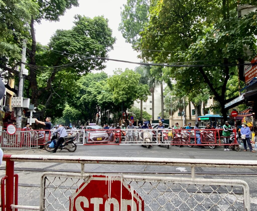 The chaos of a level crossing in Hanoi, Vietnam. Vehciles lined up across the entire road.