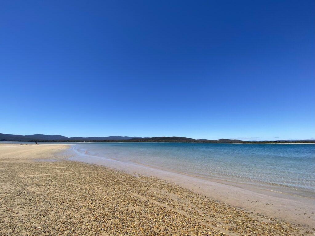 Clear blue waters of Port Sorell from Bakers Beach campground, Narawntapu National Park Tasmania.